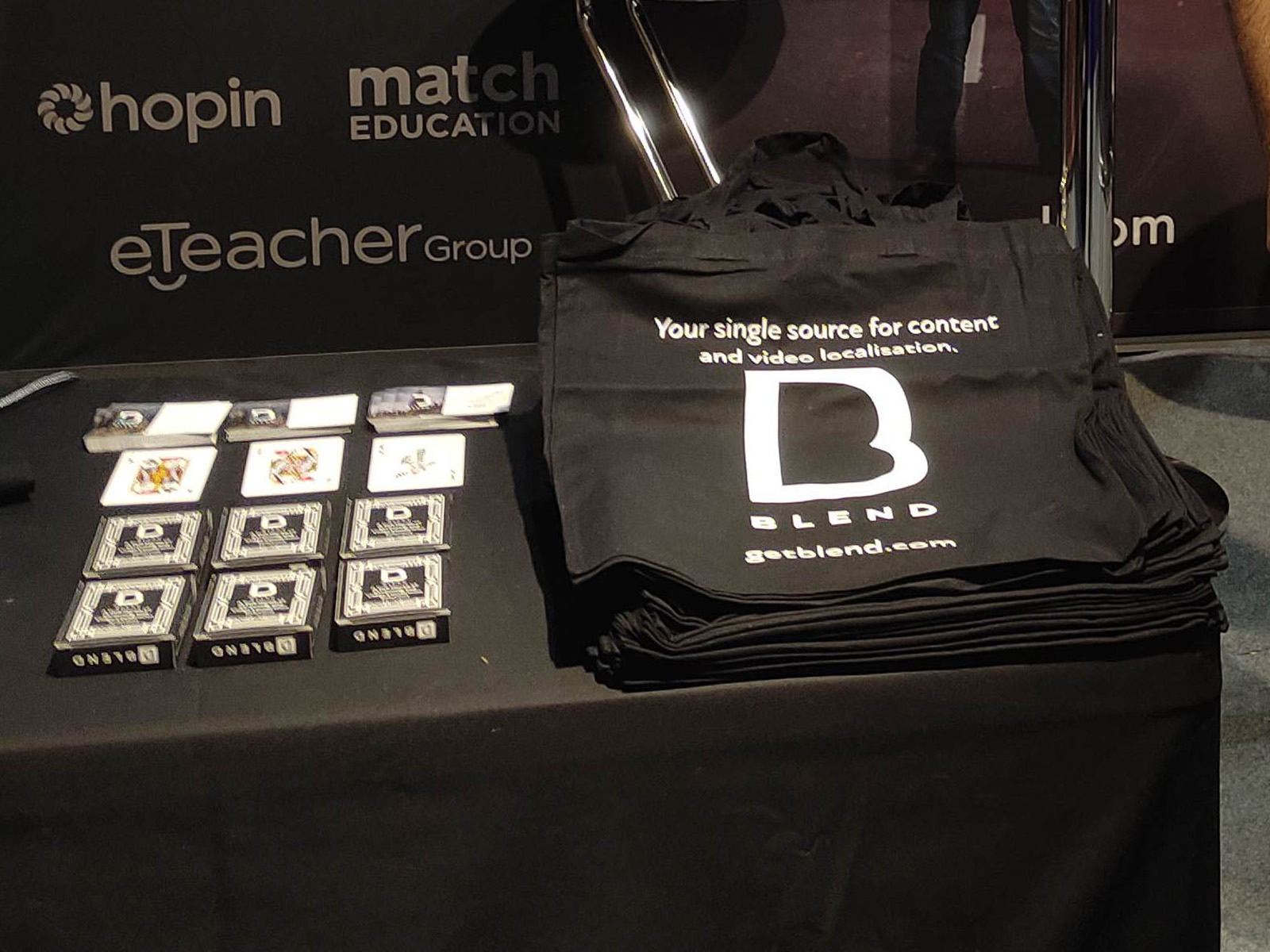 BLEND trade show booth table with swag and printed materials